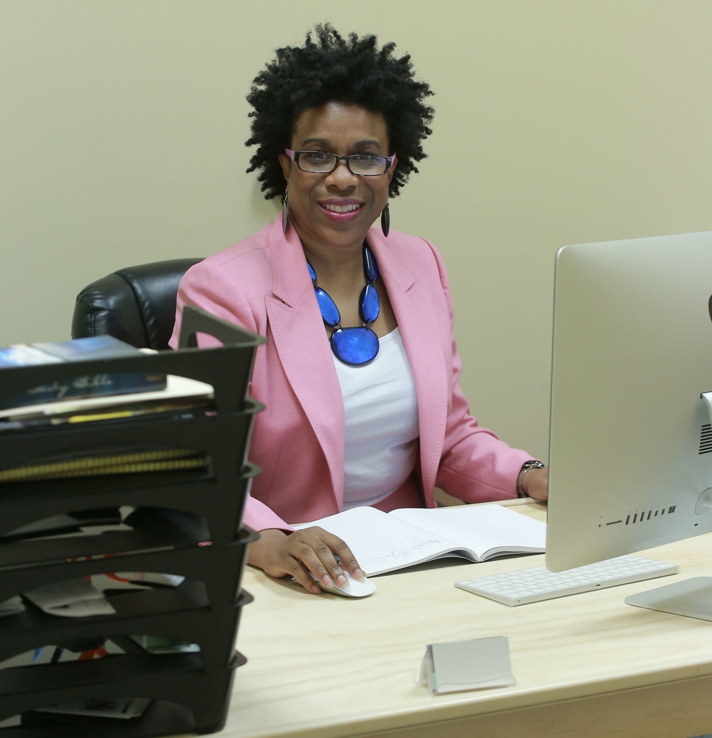 Black woman at desk working; career; coaching; strategy